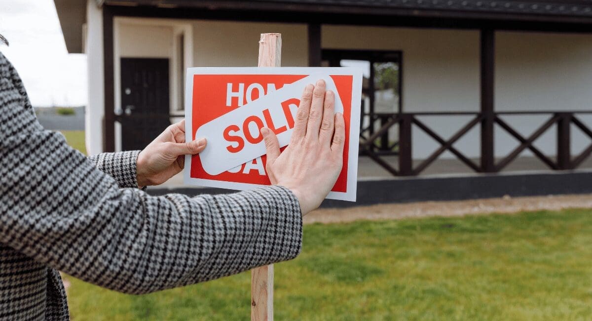 realtor putting up sale sign